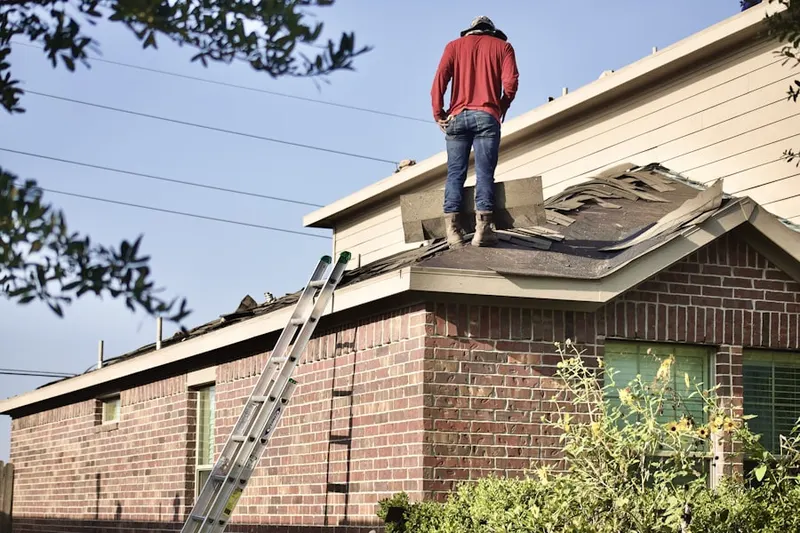 Professional roofer working on a residential roof in International Bass Lake Resort